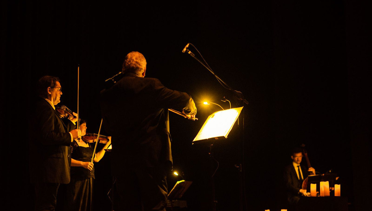 Candlelit orchestra performing on stage (illustrative stock photo)