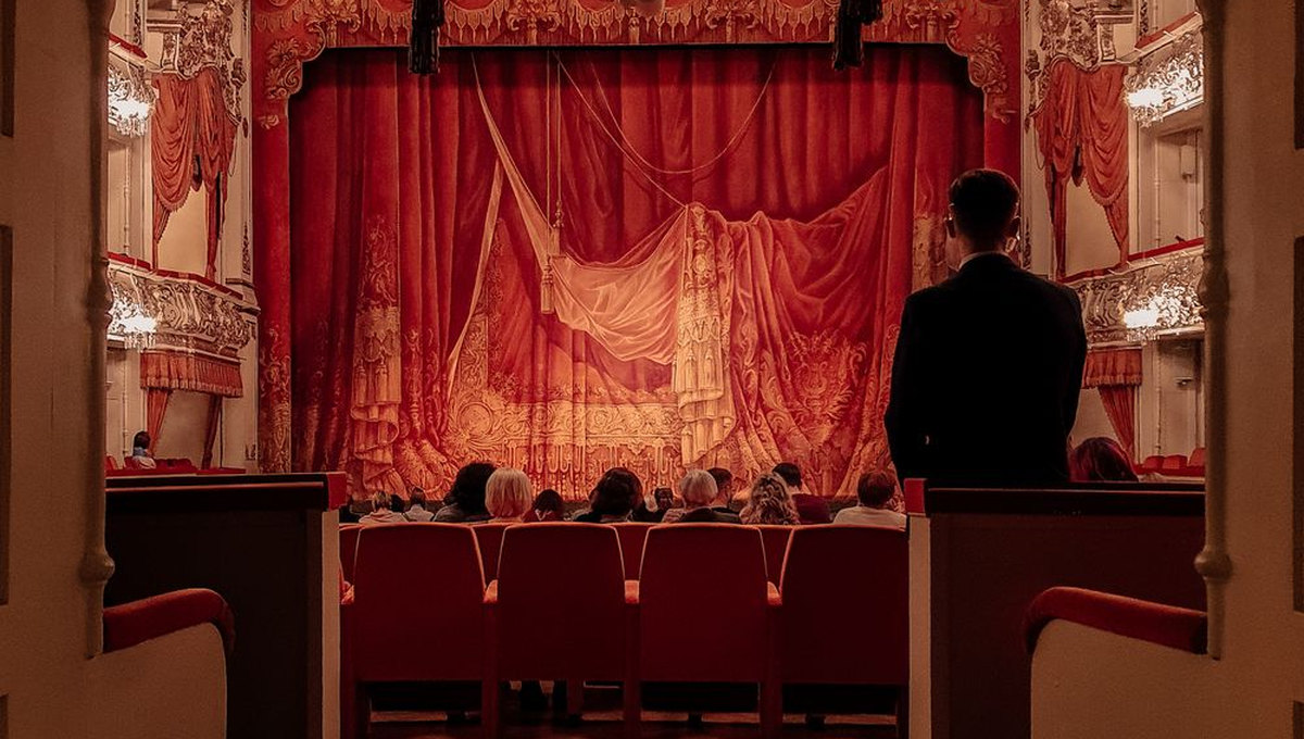 Red-curtained traditional theater interior (illustrative stock photo)
